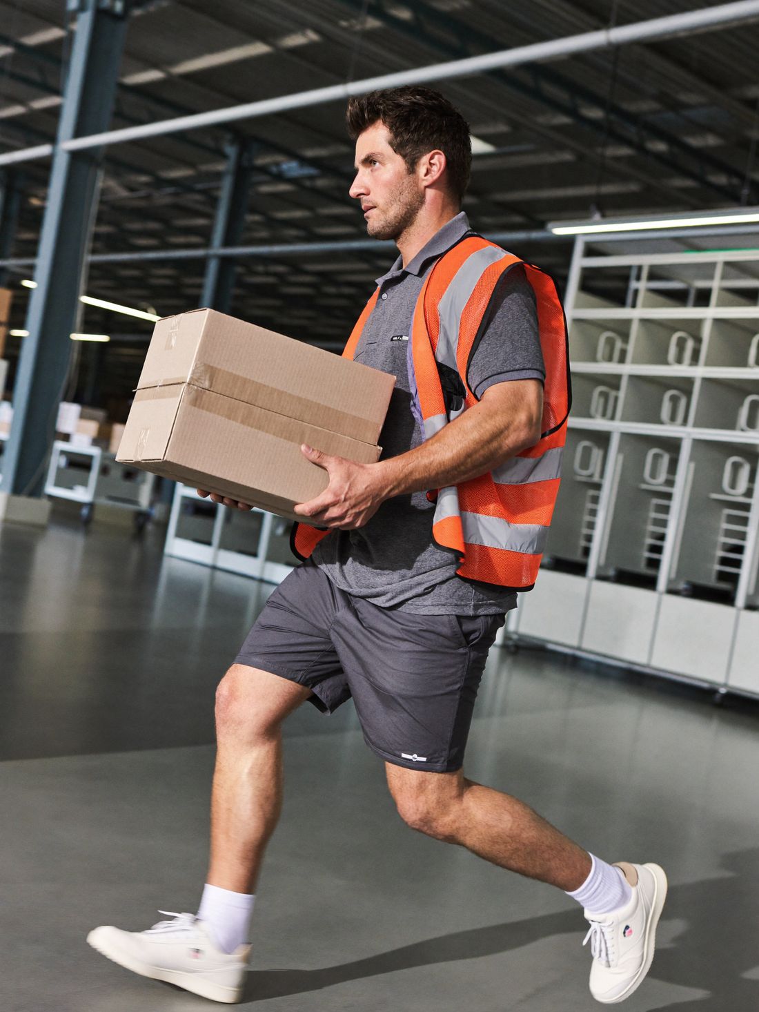 Upshifter carrying boxes across a fulfillment center floor